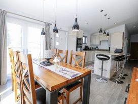 A dining area with a wooden table and chairs at Angel Lodge - No 27 Fornham St Genevieve near Bury St Edmunds