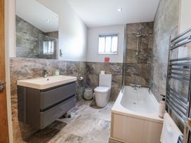 A bathroom with a sink, toilet, and shower at Angel Lodge - No 27 near Bury St Edmunds