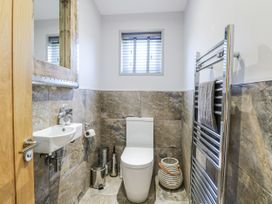 A bathroom with a sink and toilet at Angel Lodge - No 27, Fornham St Genevieve near Bury St Edmunds