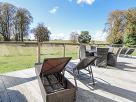 An outdoor seating area with chairs and tables at Angel Lodge - No 27 Fornham St Genevieve near Bury St Edmunds