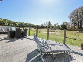 An outdoor area with a table and chairs at Angel Lodge - No 27, Fornham St Genevieve near Bury St Edmunds