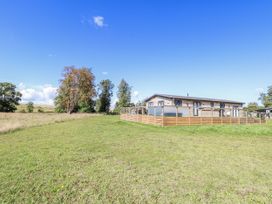 An outdoor view of a house with a fenced area at Angel Lodge - No 27 near Fornham St Genevieve