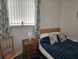 A bedroom with a bed and a chair at Seahorses