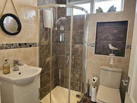 A bathroom with a shower and sink at Seahorses