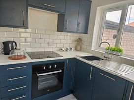 A kitchen with a sink and cabinets at Seahorses in Kinmel Bay