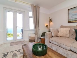 A living room with a sofa and coffee table at Combe View in Ilfracombe