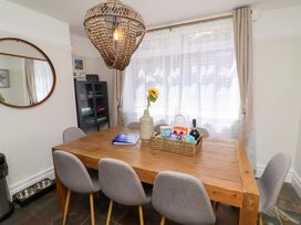 A dining room with a table and chairs at Combe View in Ilfracombe