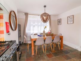 A dining room with a table and chairs at Combe View Ilfracombe