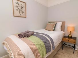 A bedroom with a bed and a lamp at Combe View in Ilfracombe