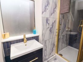 A bathroom with a sink and shower at Combe View Ilfracombe