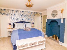 A bedroom with a bed and fireplace at Combe View in Ilfracombe