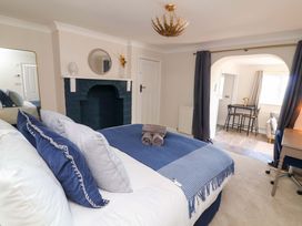 A bedroom featuring a bed and a desk at Combe View Ilfracombe