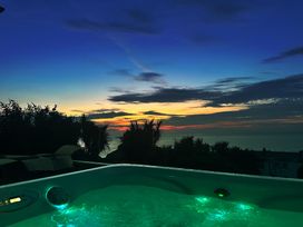 A hot tub with ocean view at Combe View in Ilfracombe