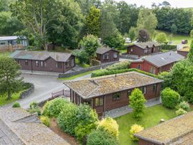 An outdoor area with lodges and greenery at Lodge 3 At Pound Farm Crook near Kendal