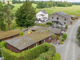 An outdoor view of several houses and greenery at Lodge 3 At Pound Farm in Crook near Kendal