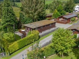 An outdoor area with cabins and greenery at Lodge 7 At Pound Farm Crook near Kendal