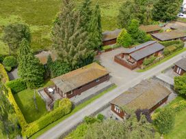 An outdoor view of cabins and greenery at Lodge 7 At Pound Farm Crook near Kendal