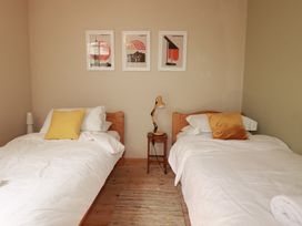 A bedroom with two single beds and posters on the wall at The Old Village Chapel Crantock