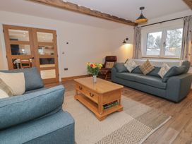 A living room with sofas and a coffee table at Y Stabl in Cerrigydrudion