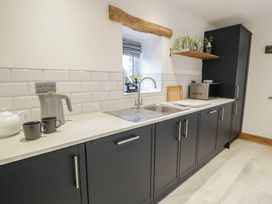 A kitchen with a sink and cabinets at Y Stabl in Cerrigydrudion