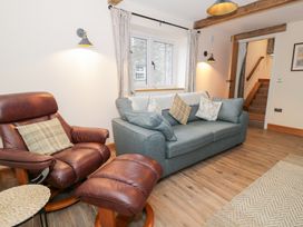 A living room with a sofa and armchair at Y Stabl in Cerrigydrudion