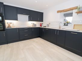 A kitchen with cabinets and appliances at Y Stabl in Cerrigydrudion