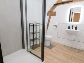 A bathroom featuring a shower, toilet, and sink at Y Stabl in Cerrigydrudion