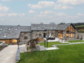 A house with a lawn and patio area at Y Côr in Cerrigydrudion