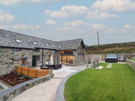An outdoor area with a stone house and garden at Y Côr in Cerrigydrudion