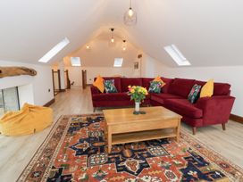 A living room with a sofa and coffee table at Y Côr in Cerrigydrudion