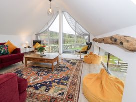 A living room with a sofa and coffee table at Y Côr in Cerrigydrudion