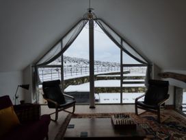 A living room with a chessboard and armchairs at Y Côr in Cerrigydrudion