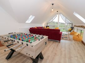 A snug with a foosball table and seating area at Y Côr in Cerrigydrudion