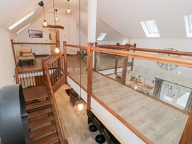 A hallway with stairs and railing at Y Côr in Cerrigydrudion