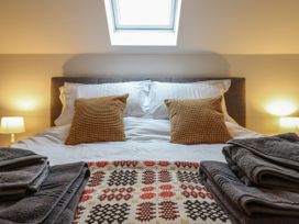 A bedroom with a bed and pillows at Y Côr in Cerrigydrudion