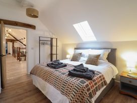 A bedroom with a bed and bedside table at Y Côr in Cerrigydrudion