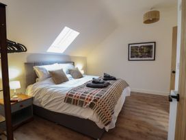 A bedroom with a double bed and a lamp at Y Côr in Cerrigydrudion
