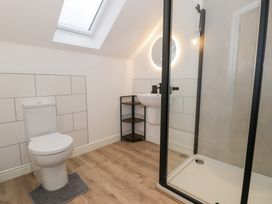 A bathroom with a shower, toilet, and sink at Y Côr in Cerrigydrudion