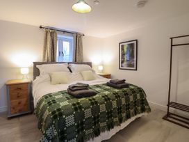 A bedroom with a bed and bedside tables at Y Côr in Cerrigydrudion