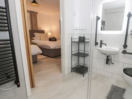 A bathroom with a shower, sink, and toilet at Y Côr in Cerrigydrudion