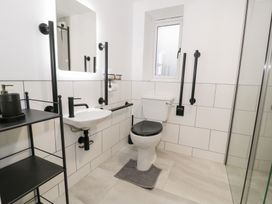 A bathroom with a toilet and sink at Y Côr in Cerrigydrudion