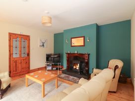 A living room with a fireplace and tv at Fort Lodge
