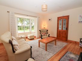 A living room with furniture and a door at Fort Lodge