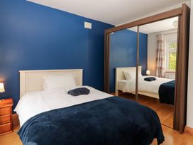 A bedroom with a bed and nightstand at Fort Lodge