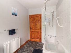 A bathroom with a shower and bathtub at Fort Lodge
