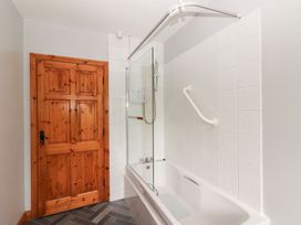 A bathroom with a shower and bath tub at Fort Lodge