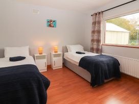 A bedroom with two beds and nightstands at Fort Lodge