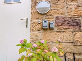 An entrance with a door and nameplate at Clematis Cottage in Whitby