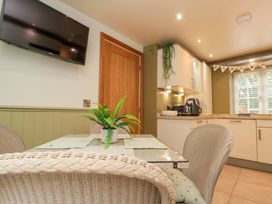 A kitchen with a table and chairs at Clematis Cottage in Whitby