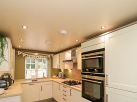A kitchen with modern cabinets and appliances at Clematis Cottage in Whitby